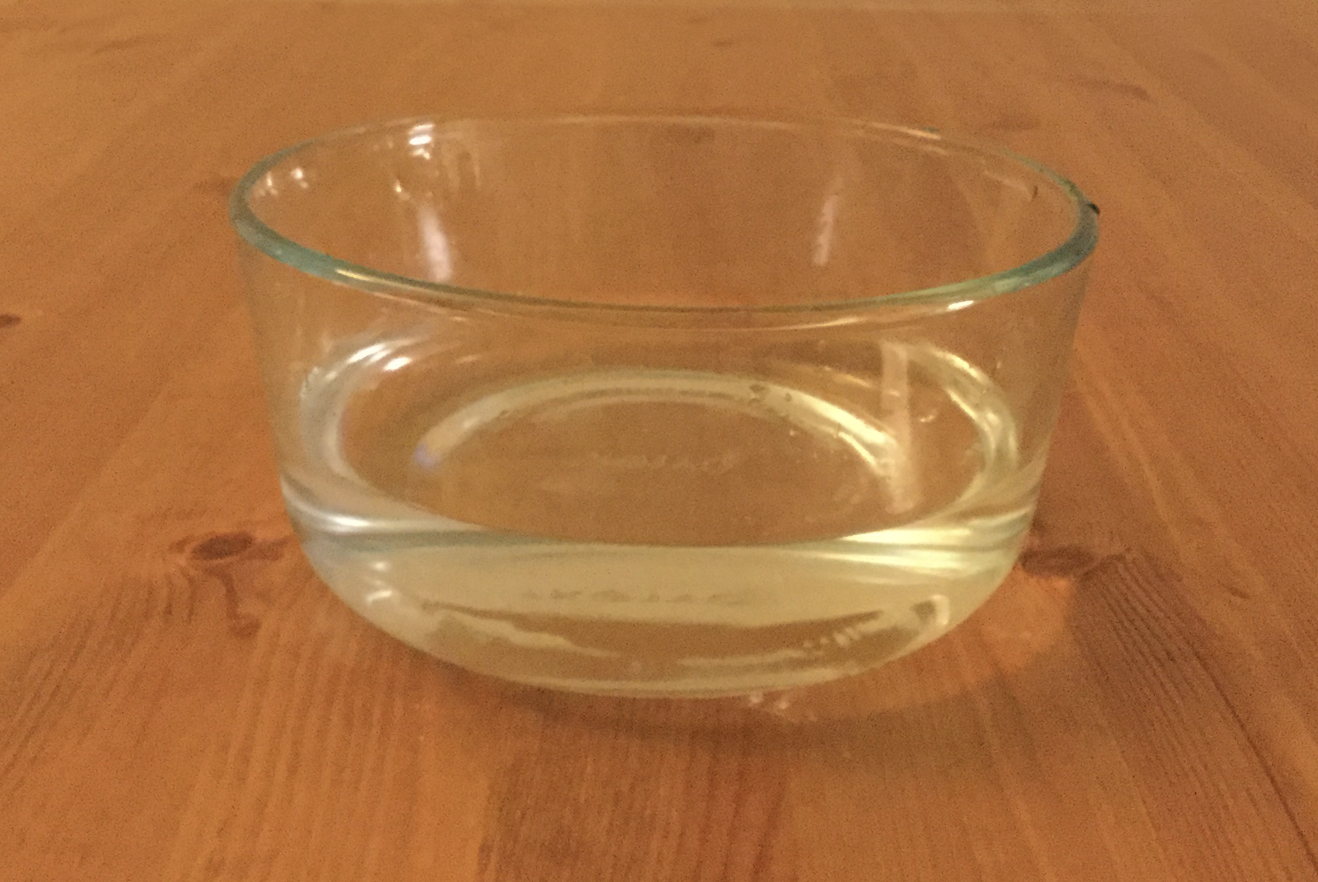 image of glass bowl full of water where the water appears very horizontal